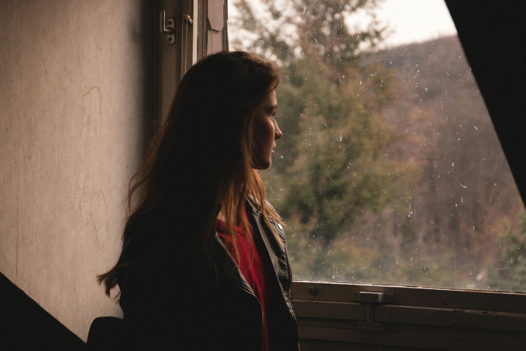 A woman looking out of a window.