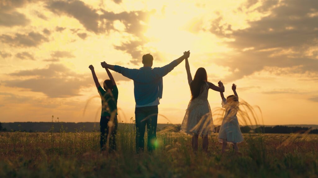 A family silhouetted against a sunset.