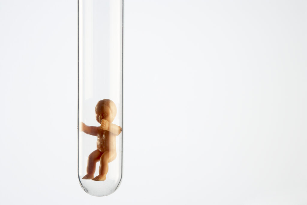 A baby figurine in a test tube.