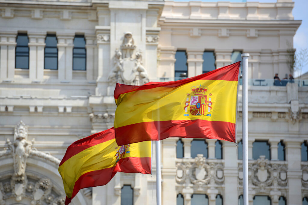 Spanish flag flying in front of the Palace of Communication in Madrid