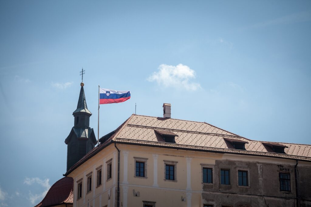 Slovenian flag waiving in the air on the castle of Ljubljana.