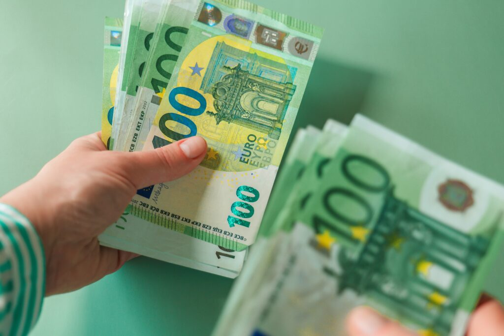 France orders life insurers to pay out after assisted suicide One,Hundred,Euro,Banknotes,In,Female,Hands,On,A,Green