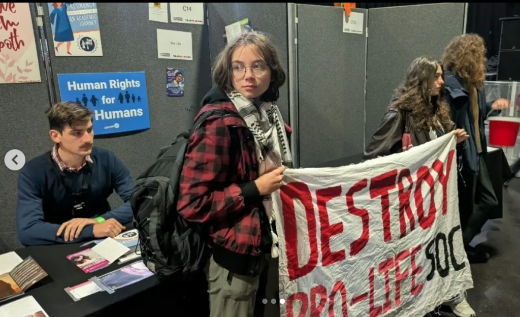 protestor at manchester pro life society stall